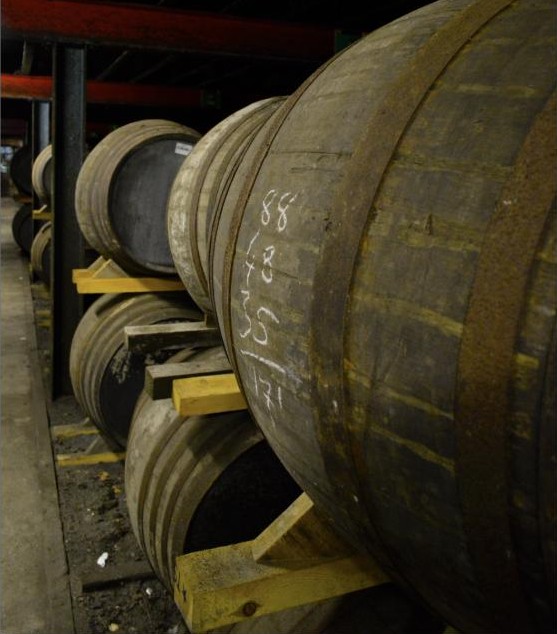 Racked casks, chalk-marked for identification, inside a dunnage warehouse at Lagavulin Distillery, Islay.